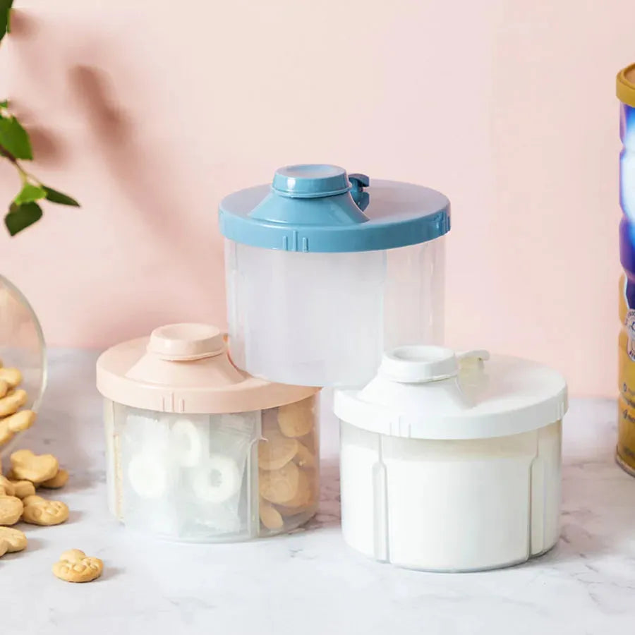Three portable 4-compartment baby food and formula dispensers in blue, pink, and white.