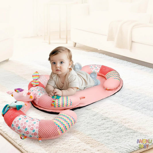 Baby activity mat with pink U-shaped pillow, colorful toys, and a baby on a soft rug.