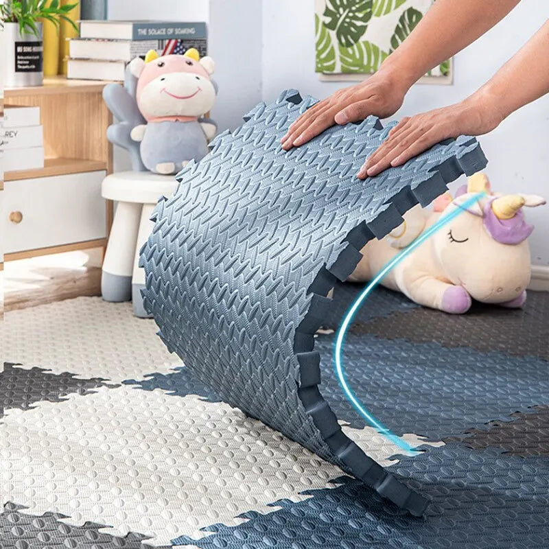 Soft blue and white interlocking EVA foam puzzle play mat for babies and toddlers.