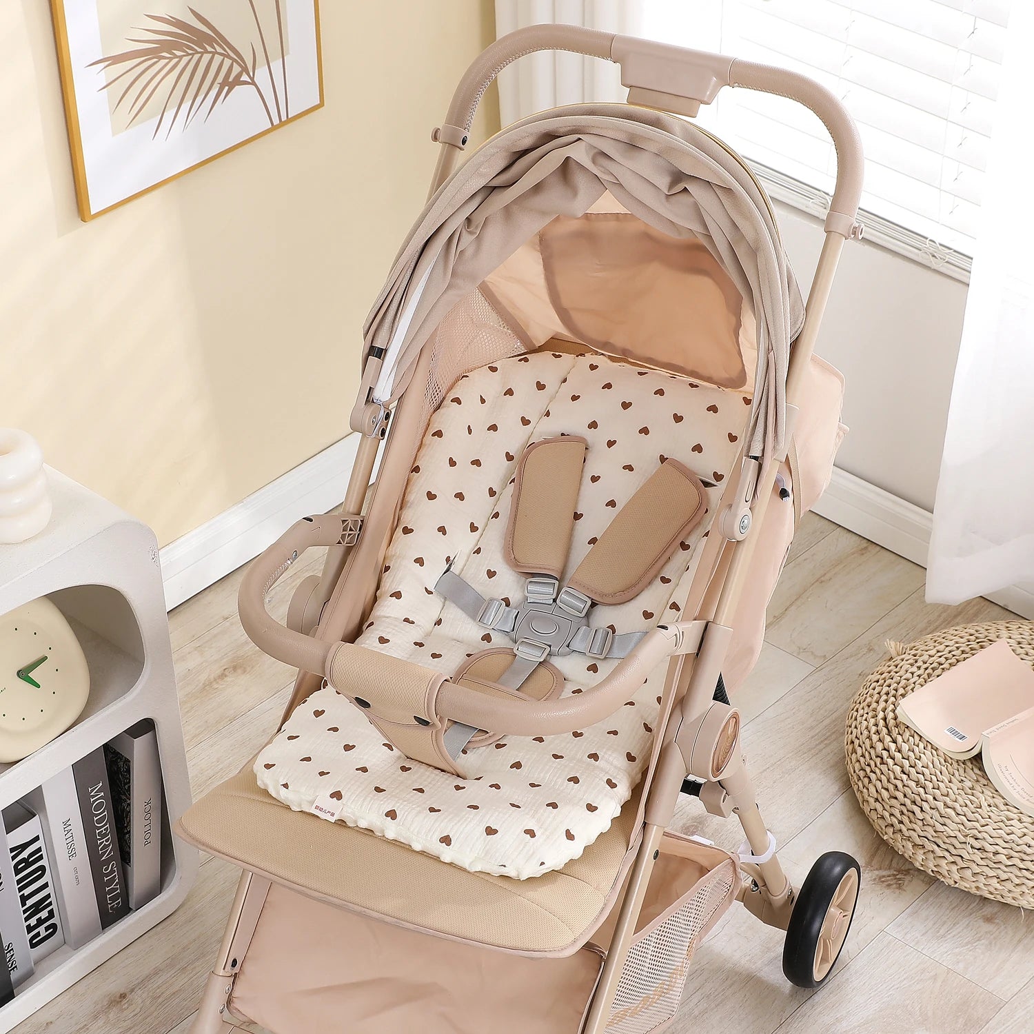 Beige stroller with a soft, universal heart-patterned cotton-polyester seat cushion and safety harness.