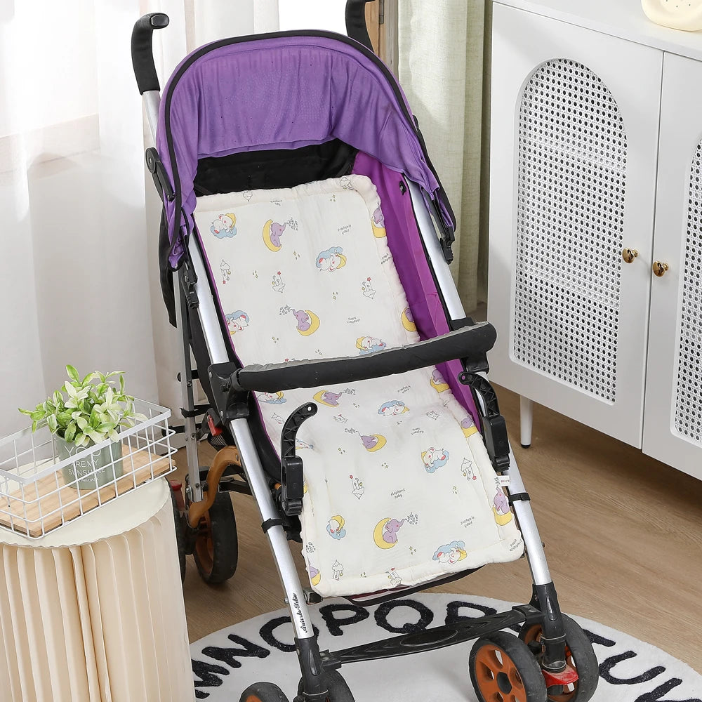 Soft white cotton stroller cushion with colorful elephant and moon print in a purple stroller.