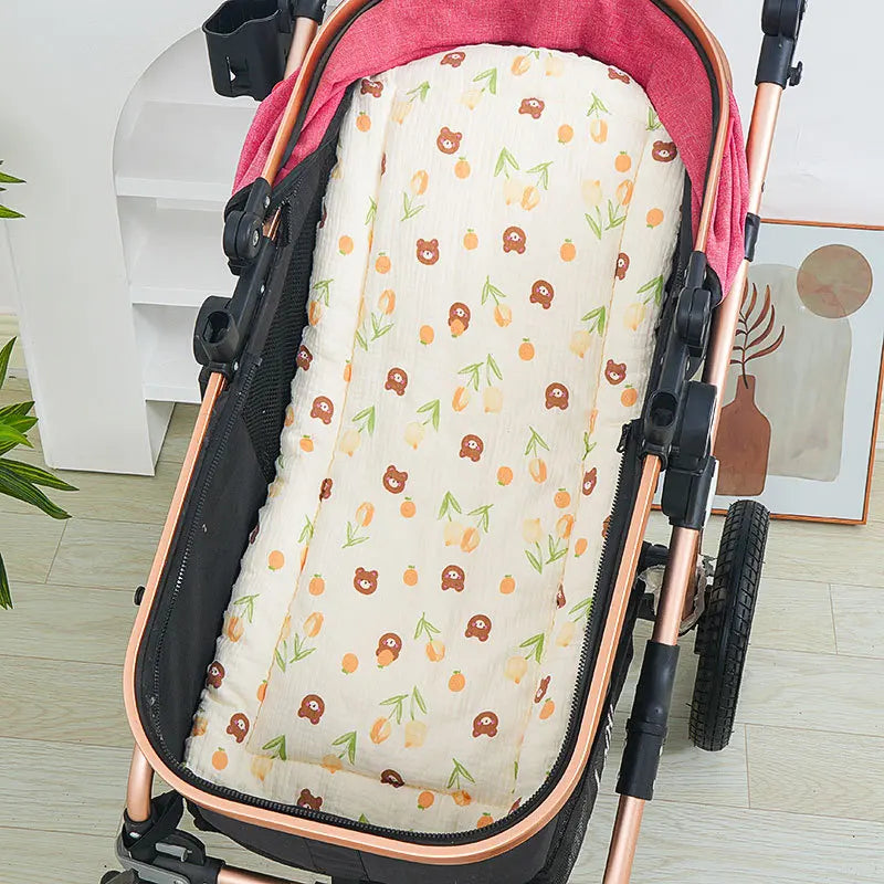 Soft cotton stroller cushion with cute bear and tulip print, fitting a pink and black stroller.