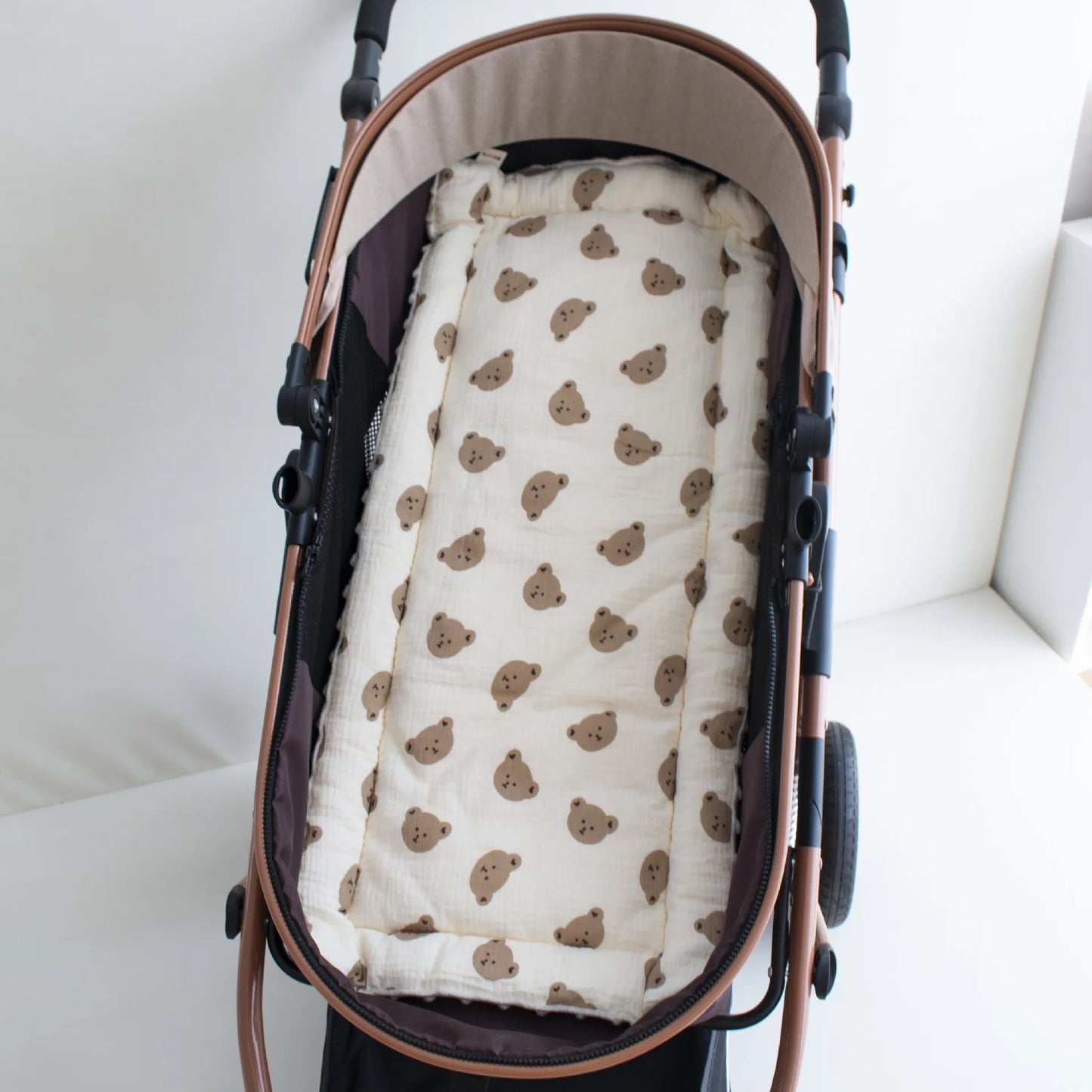 Soft beige cotton stroller cushion with brown bear print, universal fit, for baby comfort.