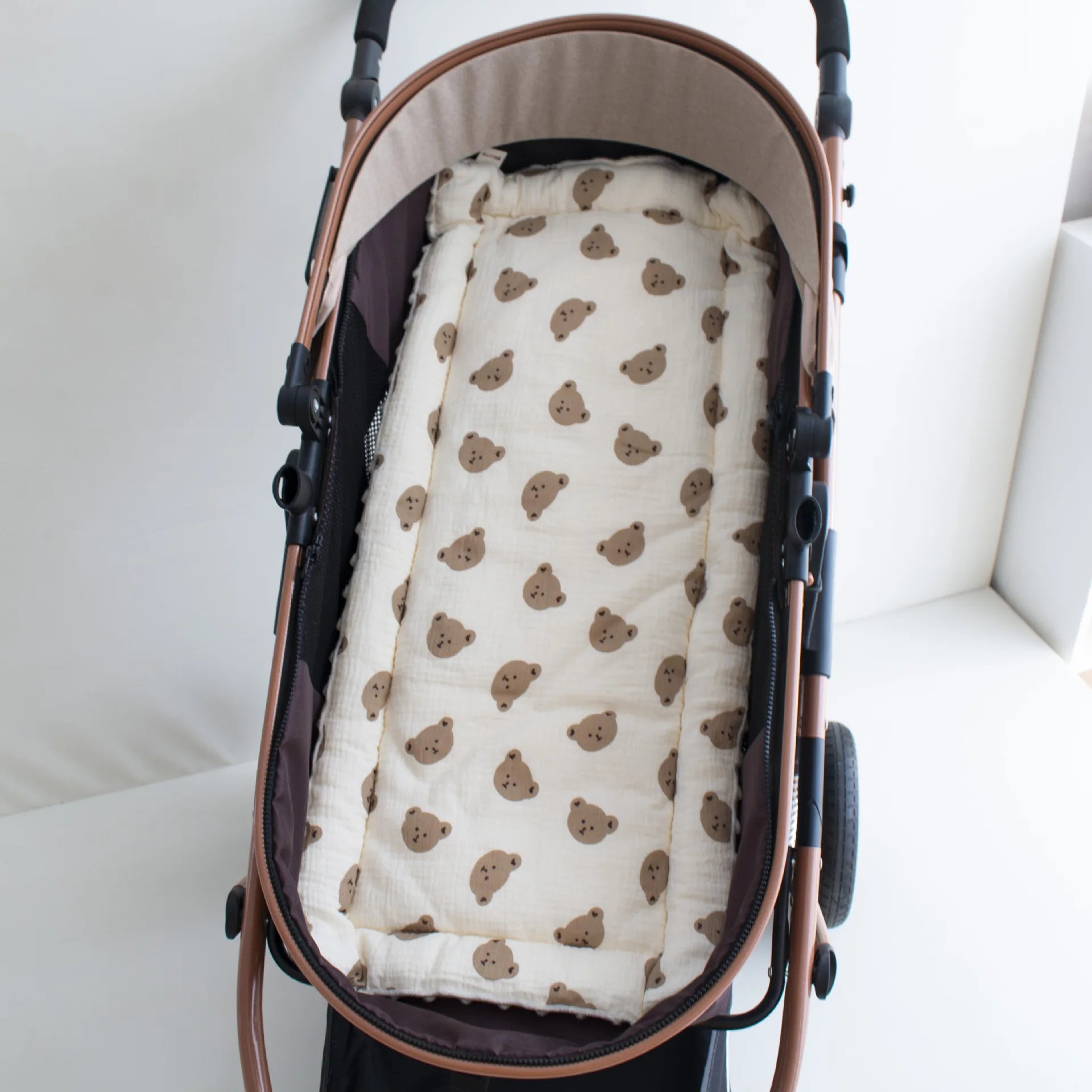 Soft beige cotton stroller cushion with brown bear print, universal fit, for baby comfort.