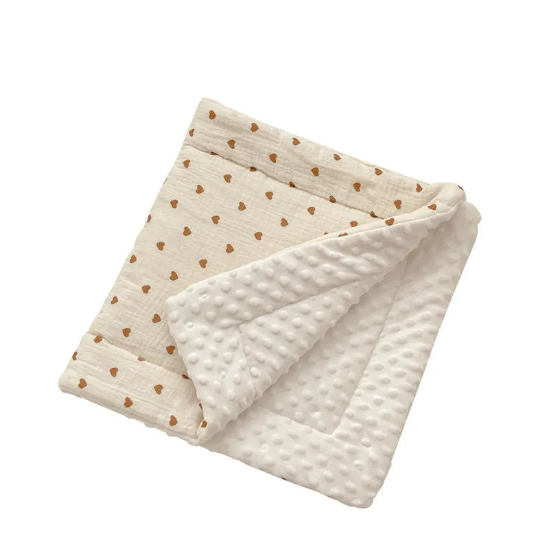 Soft beige stroller cushion with brown heart pattern and white bumpy minky fabric lining.