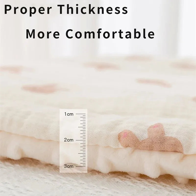 Soft, breathable cotton-polyester stroller mattress pad in cream with subtle pink animal prints, showing a 2cm thickness.