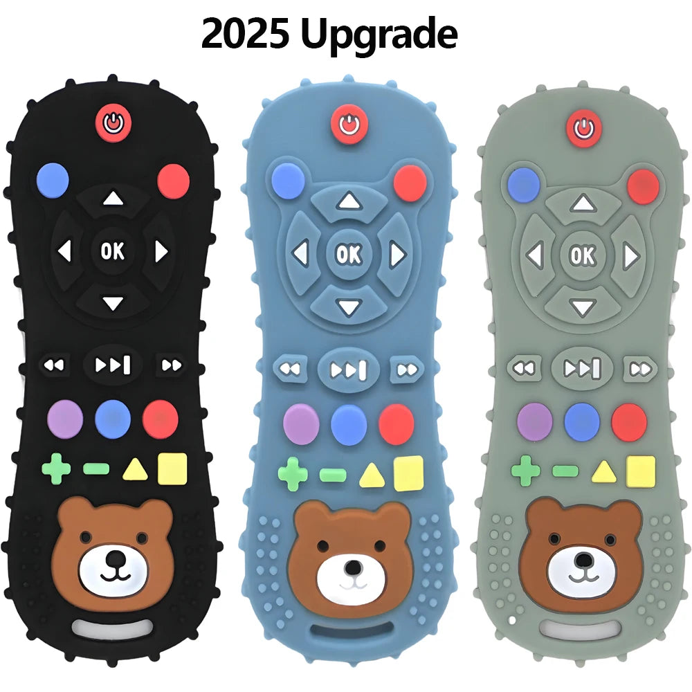 Three silicone baby teethers shaped like remote controls in black, blue, and sage green, with a bear face.