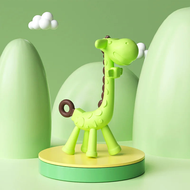 Green silicone giraffe baby teether with brown spots, standing on a yellow and green platform.