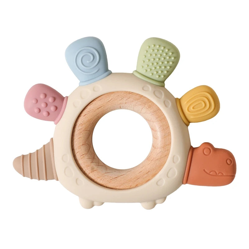 Multicolor silicone dinosaur baby teether with a natural wood ring, textured for soothing gums.
