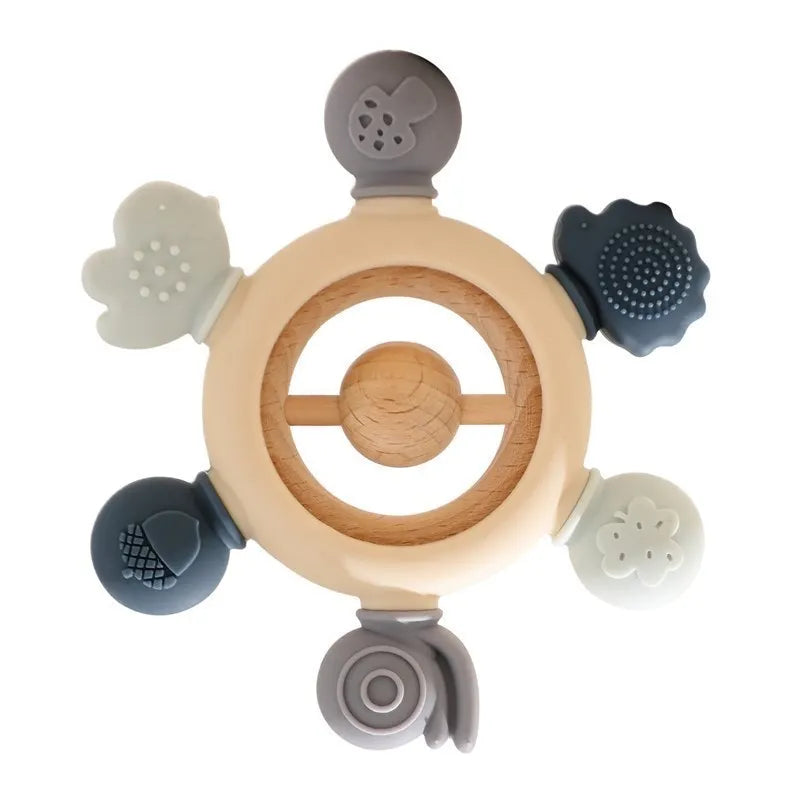 Montessori forest-themed soft silicone and wood baby teether with mushroom, snail, and flower shapes.