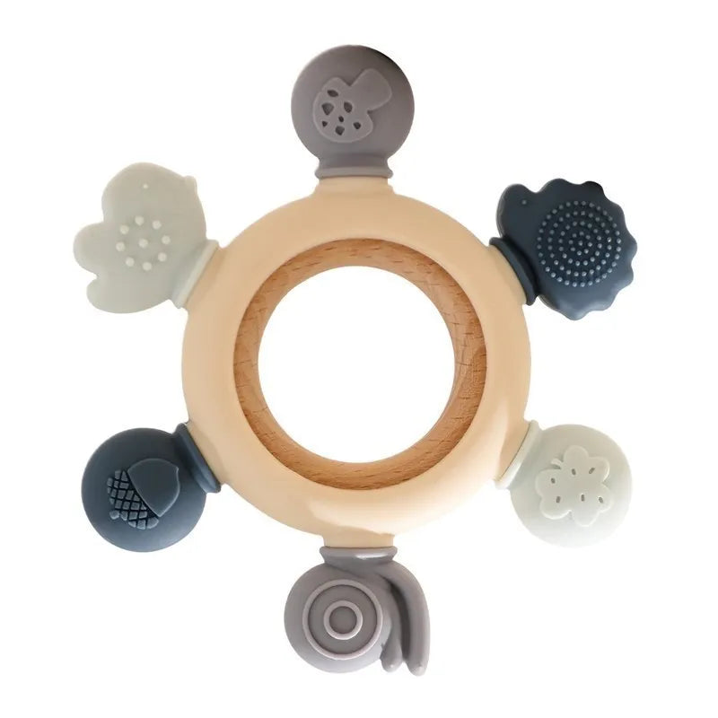Montessori forest-themed baby teether with a wooden ring and soft silicone attachments in muted colors.