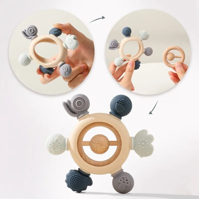Montessori forest-themed baby teether with soft silicone and natural wood ring, featuring snail, acorn, and mushroom shapes.