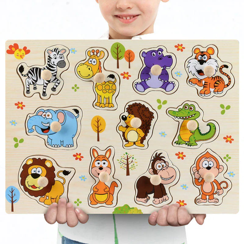 Child holding a wooden Montessori animal puzzle with colorful zebra, giraffe, hippo, tiger, elephant, and more.