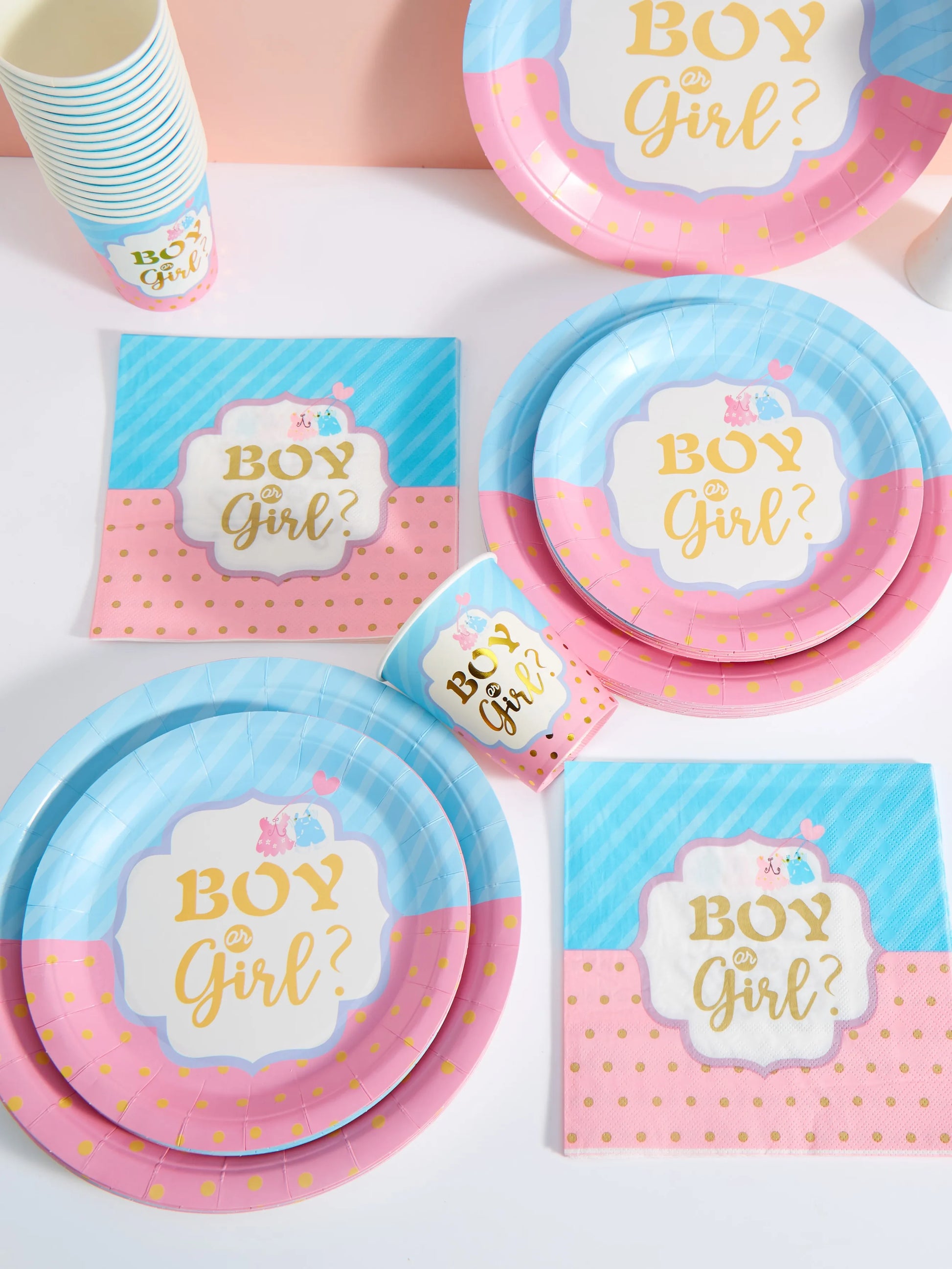Pink and blue disposable party set with "Boy or Girl?" design, including plates, cups, and napkins.