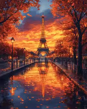 Eiffel Tower at sunset paint by numbers kit, featuring vibrant orange and red autumn trees reflecting in a wet street.