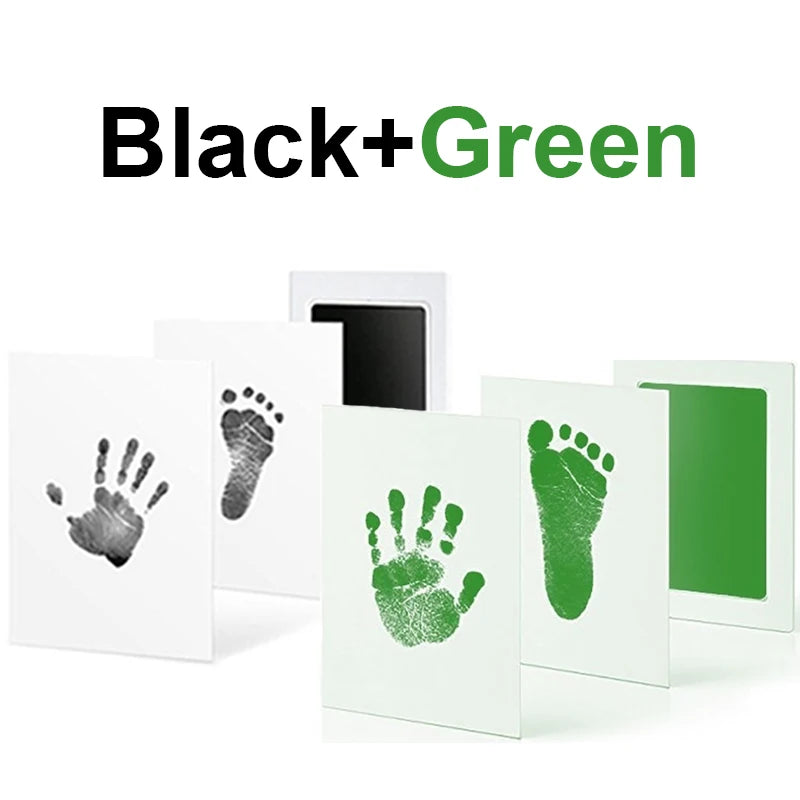 Baby handprint and footprint inkless kit with black and green prints on white cards.