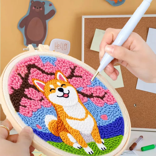 Punch needle embroidery kit with a cute Shiba Inu design under pink cherry blossoms.