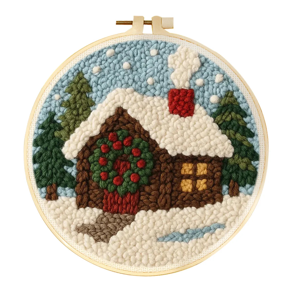 Punch needle winter landscape craft kit with a cozy cabin, snow, trees, and a festive wreath.