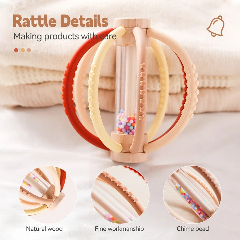 Wooden baby rattle with silicone rings in red, yellow, and beige, featuring a clear rain drum and chime beads.