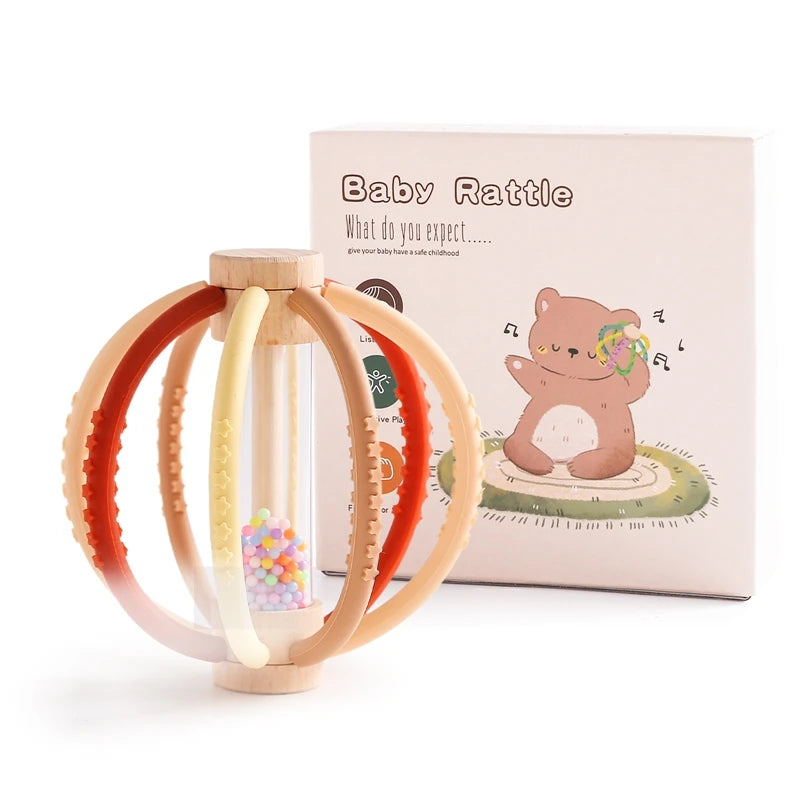 Wooden baby rattle with colorful silicone teether rings, clear rain drum, and gift box.