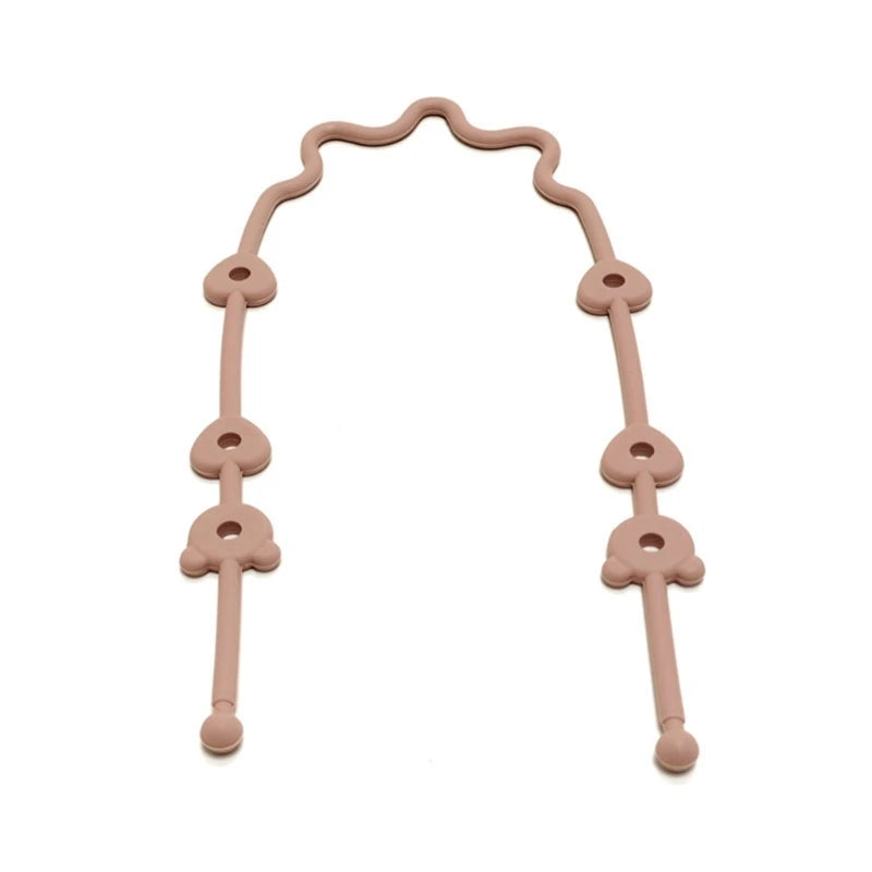 Pink silicone universal pacifier and bottle strap with adjustable heart-shaped loops.
