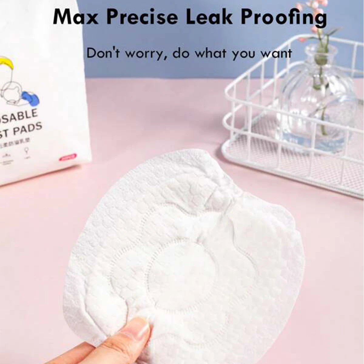 White disposable nursing pad with a soft, textured surface, held by fingers.