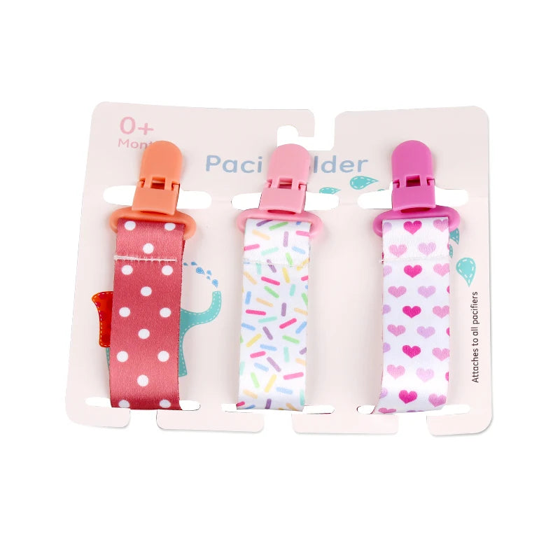 Set of 3 colorful polyester pacifier clips with plastic clasps, featuring polka dots, sprinkles, and heart patterns.