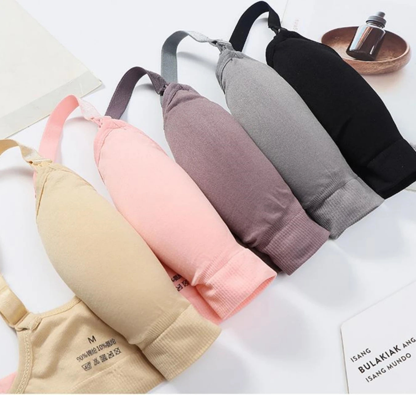 Seamless, breathable nursing and maternity bras in beige, pink, purple, grey, and black.