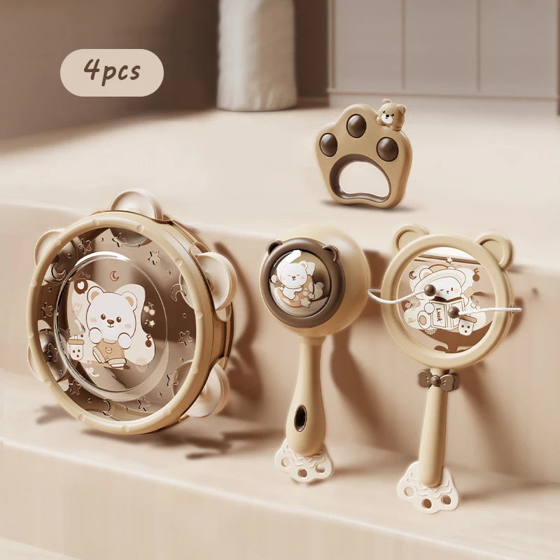 Montessori musical baby toy set: 4 beige rattles with bear designs, including a tambourine and paw-shaped teether.
