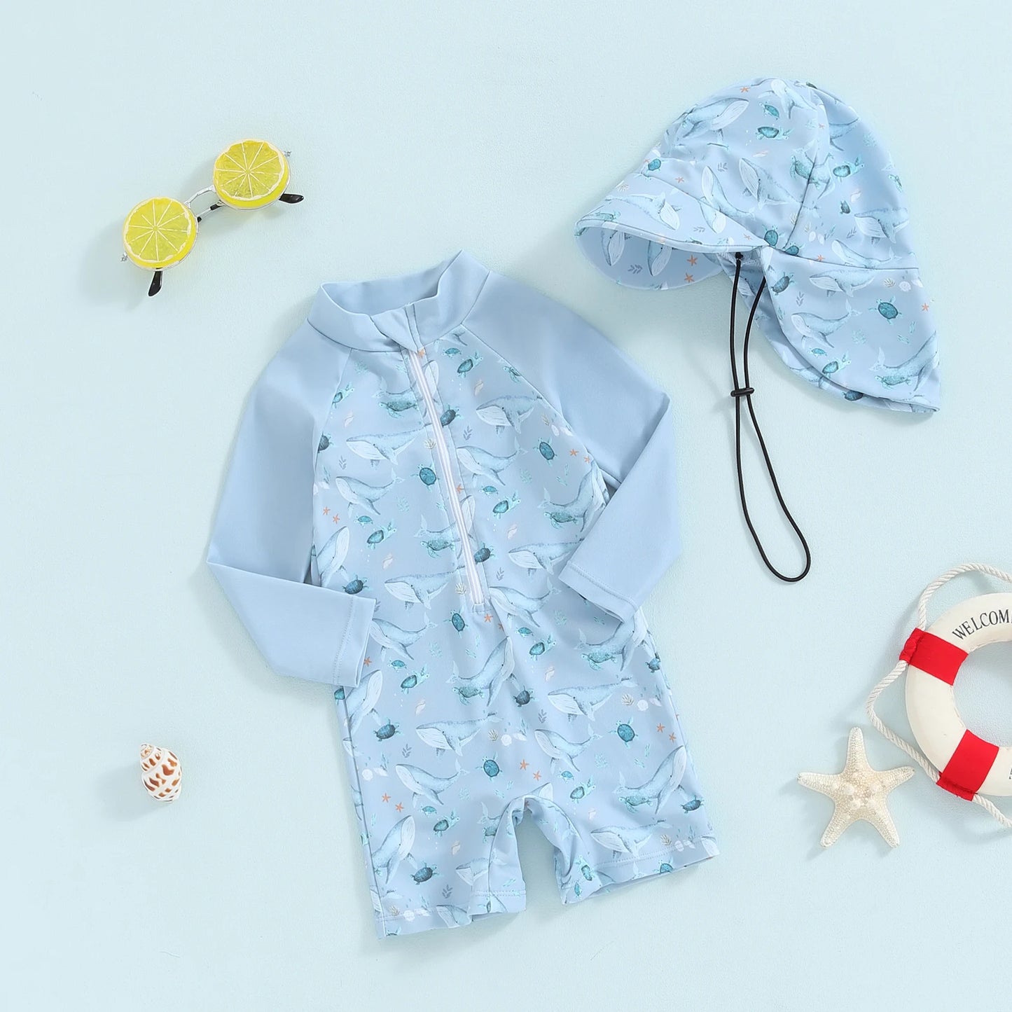 Light blue baby long-sleeve swimsuit with whale print and matching sun hat for sun protection.