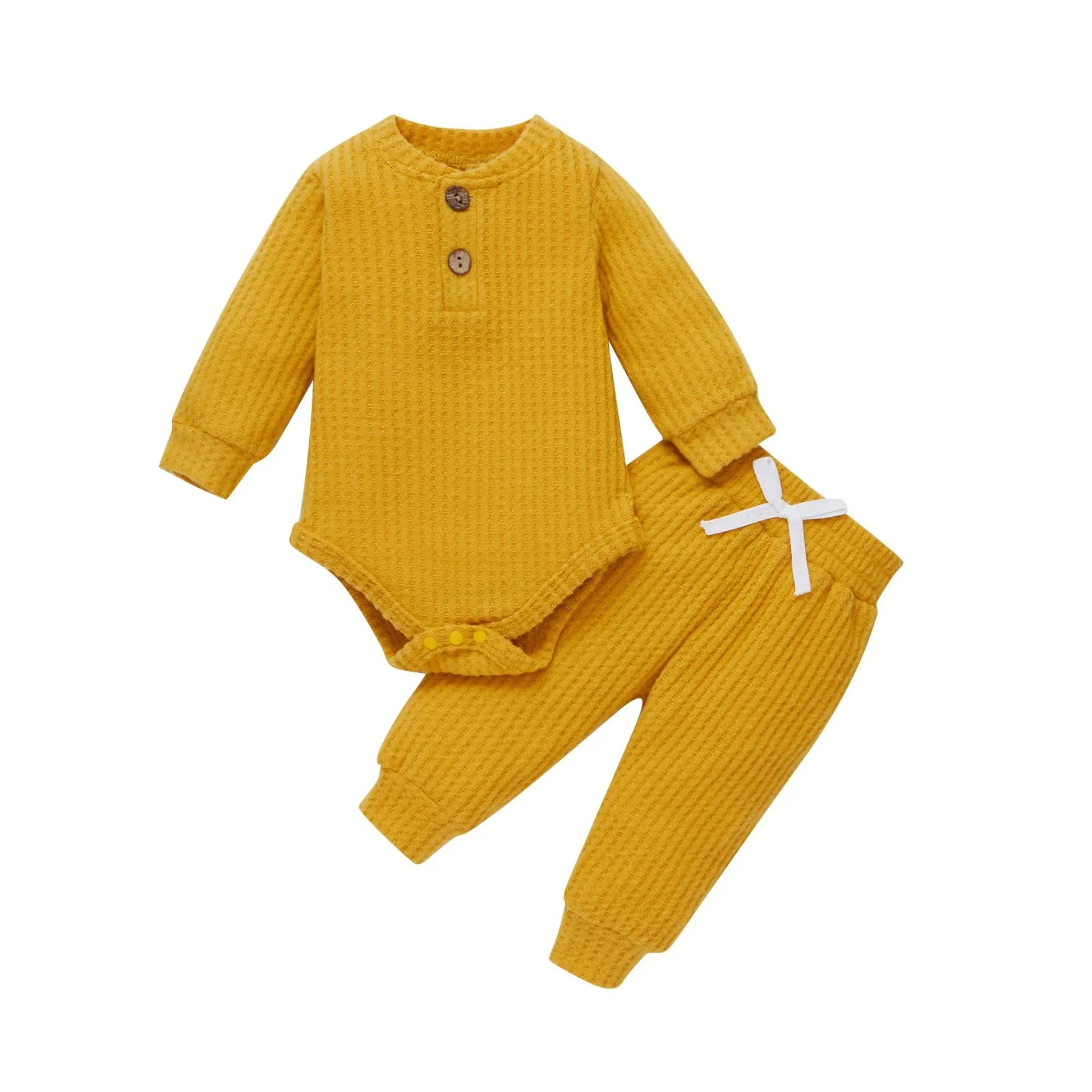 Mustard yellow waffle knit long-sleeve baby bodysuit and matching pants with white drawstring.