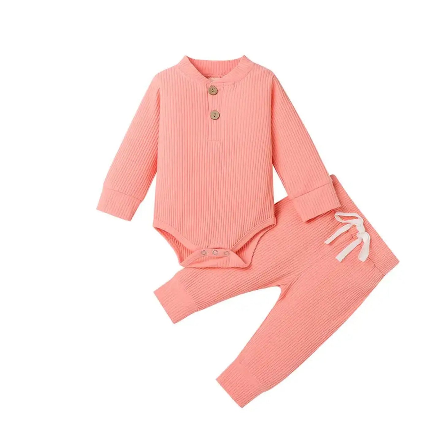Pink ribbed cotton long-sleeve baby bodysuit with wooden buttons and matching pants with white drawstring.