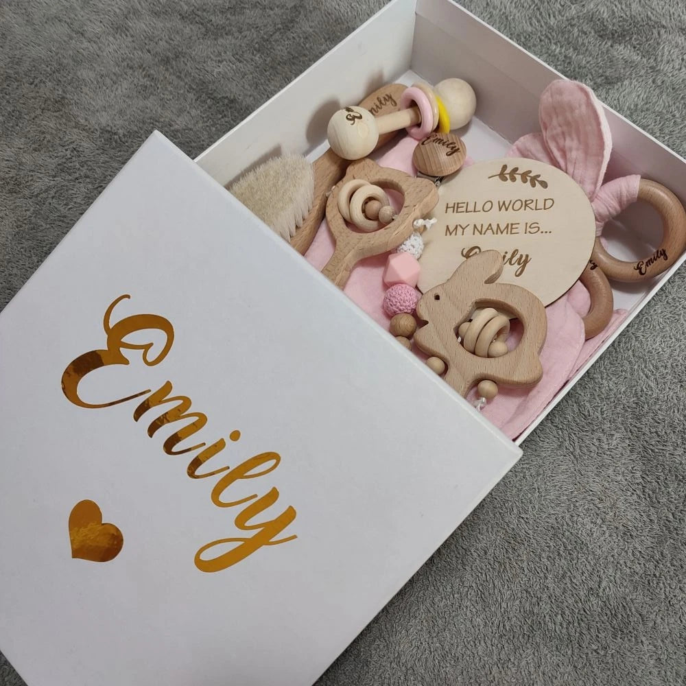 Personalized 8-piece natural wood baby gift set with rattles, brush, and pacifier clip in a white box.