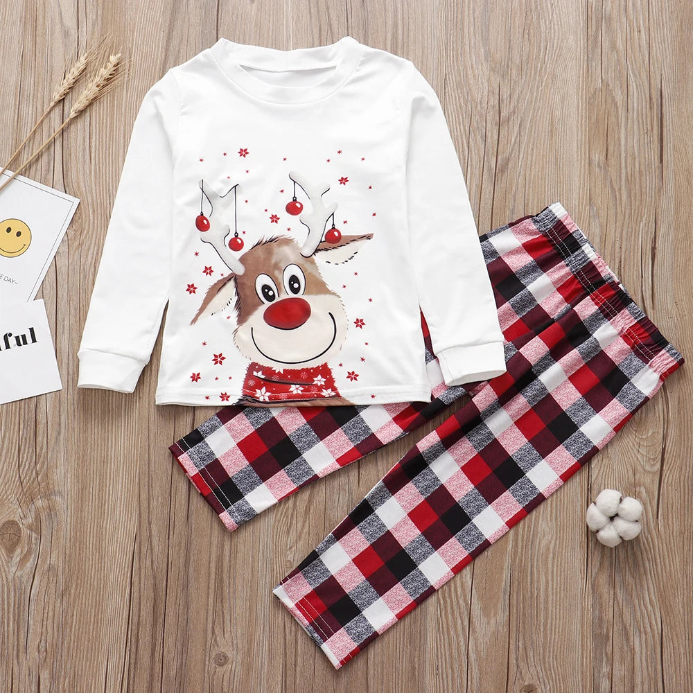 White long-sleeve Christmas pajama set with a reindeer graphic and red plaid pants.