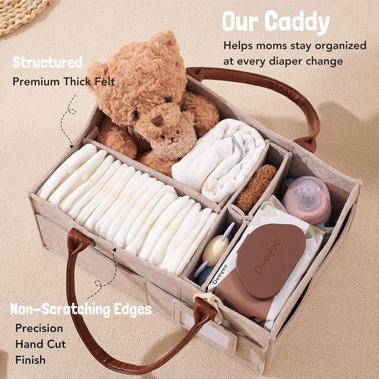 Beige felt diaper caddy with brown leather handles, organized with diapers, wipes, bottles, and a teddy bear.