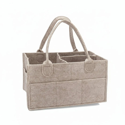 Beige felt portable diaper caddy with dividers and outer pockets.