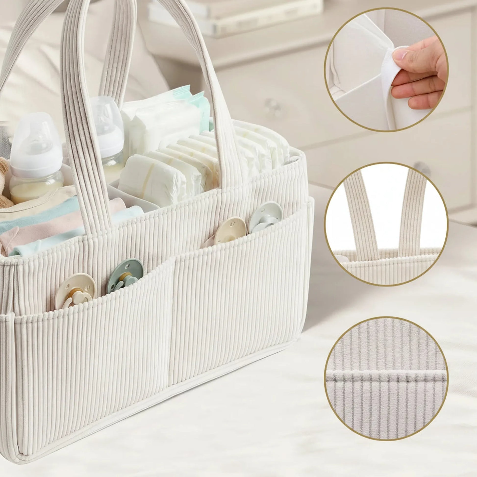 Beige corduroy diaper caddy with internal dividers, outer pockets, and long handles, filled with baby essentials.