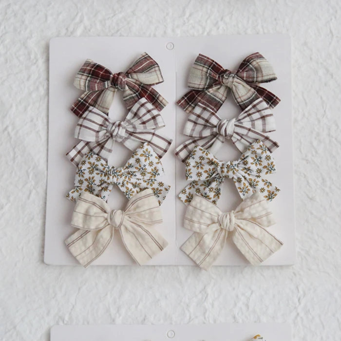 Set of eight cotton hair bows for girls in plaid, floral, and striped patterns, 7.5cm.