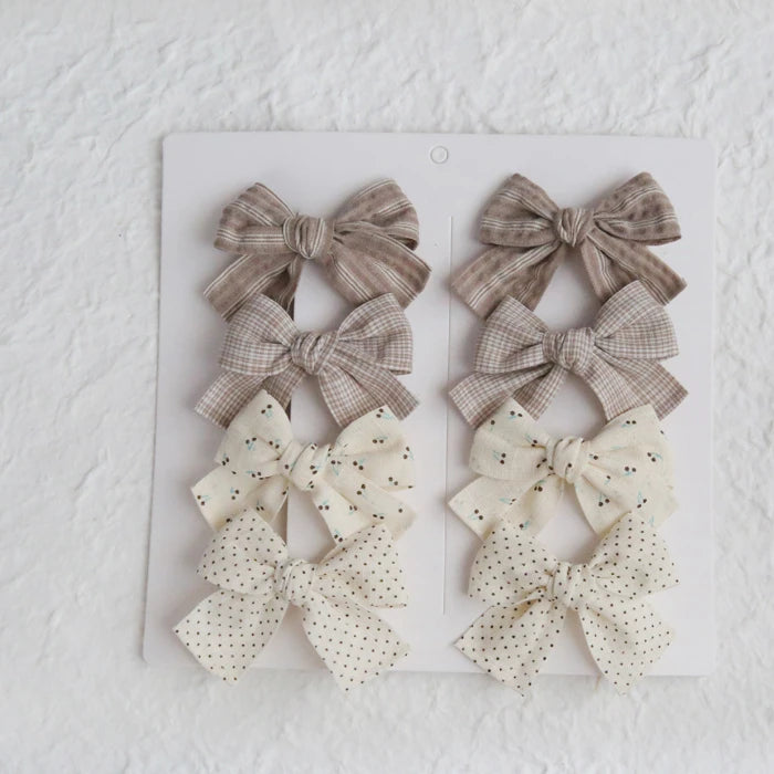Set of 8 girls' cotton hair clips with elegant bows in plaid, polka dot, and floral patterns.