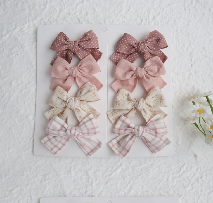 Set of 8 girls' cotton hair bows in pink, polka dot, floral, and plaid designs.