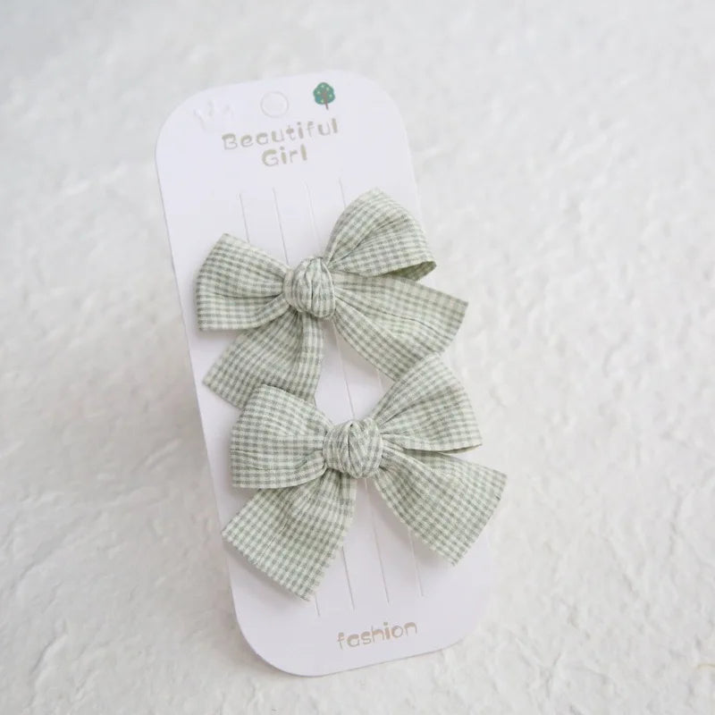 Two green gingham cotton hair bows for girls on a "Beautiful Girl" card.