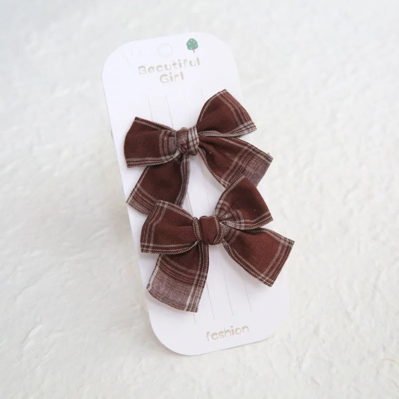 Two brown plaid cotton hair bows for girls, 7.5cm, on a white "Beautiful Girl" card.