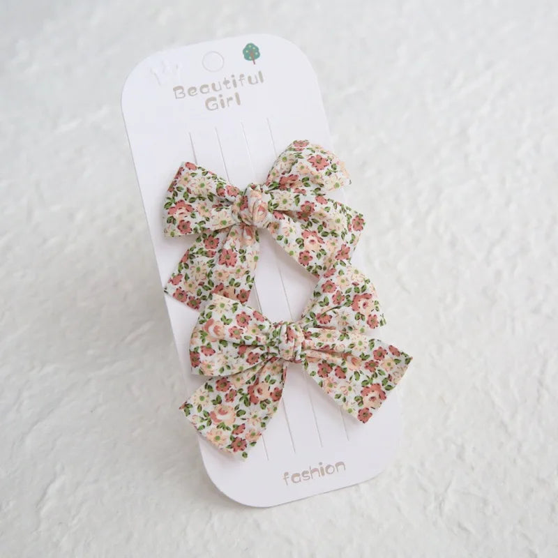 Two floral cotton hair bows for girls, 7.5cm, with 4cm clips, on a "Beautiful Girl" card.
