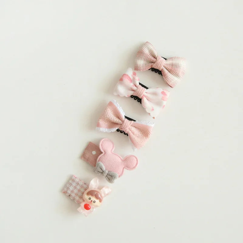 Set of five pink and white baby hair clips with bows, a mouse, and a bunny design.