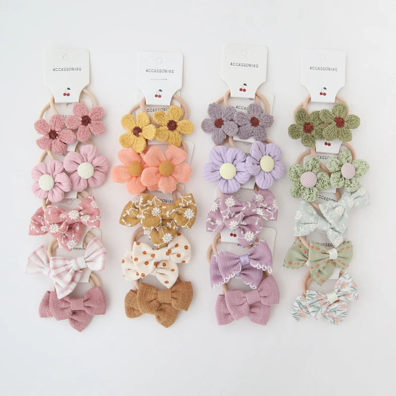 Four sets of 10 handmade cotton floral and bow hair ties for girls in pink, yellow, purple, and green.