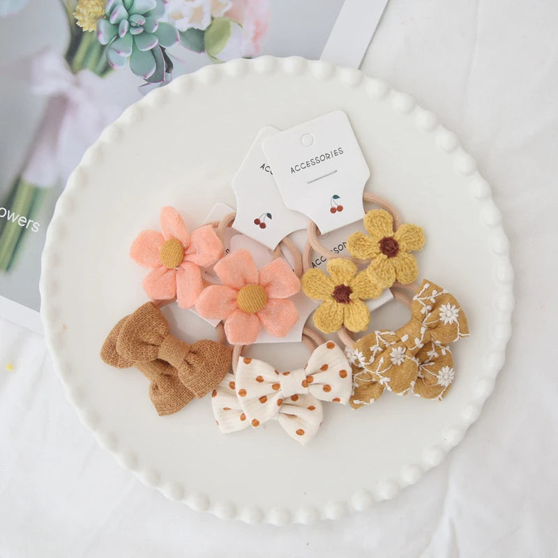 Handmade cotton hair ties for girls: 10-pack with peach flowers, yellow flowers, and various bow designs.