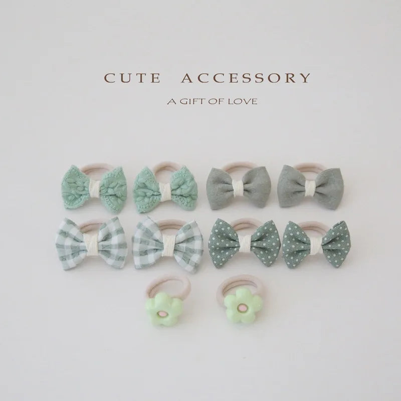Set of 10 girls' cotton hair ties and clips in green and gray, featuring bows and flower designs.