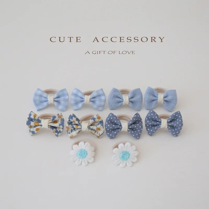 Set of 10 girls' cotton hair accessories: blue gingham, floral, polka dot bows, and white daisy clips.