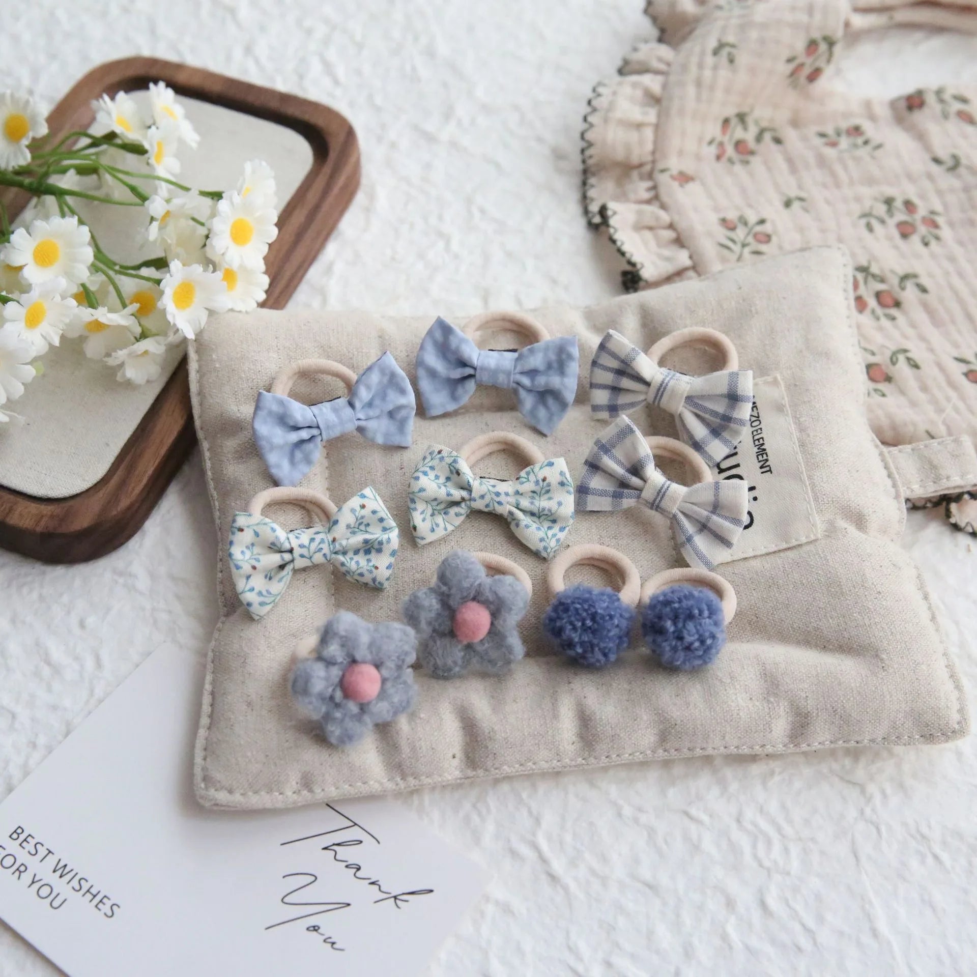10-pack of girls' cotton hair ties and clips: blue bows, floral, and pom-pom designs.