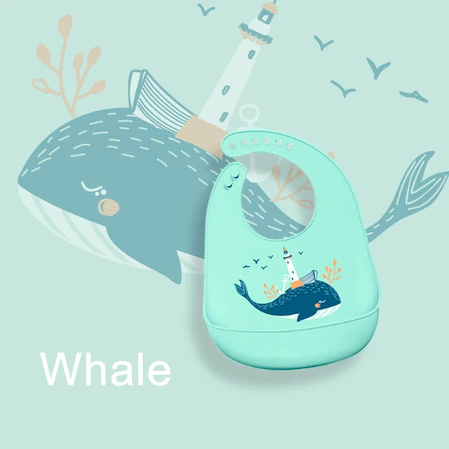 Adjustable soft silicone baby bib in light blue with a whale and lighthouse design.